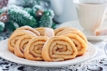 Biscuit festive roll with apple jam on a white bowl, horizontal