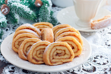 Biscuit festive roll with apple jam on a white bowl, horizontal