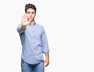 Young handsome business man over isolated background doing stop sing with palm of the hand. Warning expression with negative and serious gesture on the face.