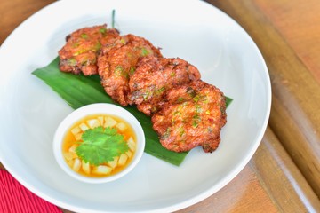 Tod Mun Pla or Thai Fish Cakes on a White Plate