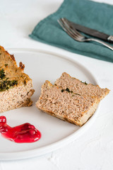 Chicken and liver pate with cranberry sauce, served on plate.