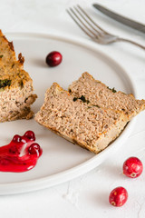 Chicken and liver pate with cranberry sauce, served on plate.