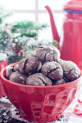 Homemade chocolate cookies with cracks. Biscuits with icing sugar. Selective focus
