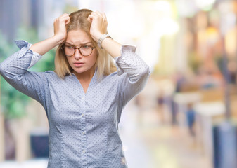 Young caucasian business woman wearing glasses over isolated background suffering from headache desperate and stressed because pain and migraine. Hands on head.