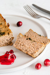 Chicken and liver pate with cranberry sauce, served on plate.