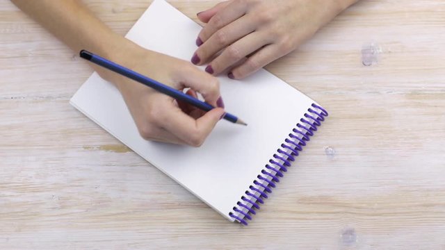 Hand writing the word "Hello"