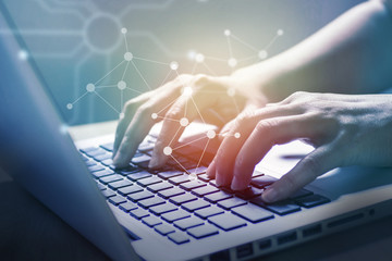 Hand of business woman working on laptop with social network concept