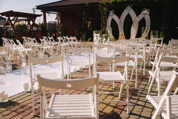 White chair on wedding ceremony. Outside. Summer time