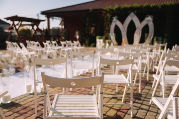 White chair on wedding ceremony. Outside. Summer time