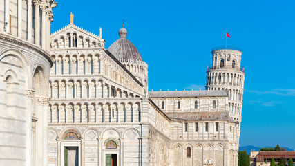 Fototapeta na wymiar Day view of Pisa Cathedral with Leaning Tower of Pisa on Piazza dei Miracoli in Pisa, Tuscany, Italy. The Leaning Tower of Pisa is one of the main landmark of Italy
