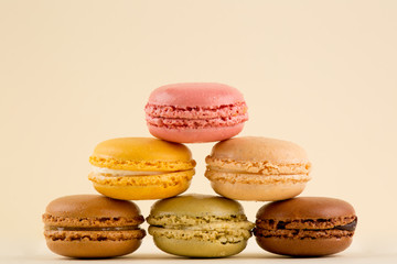 Macarons Pile, Beautiful multiple Colored Stack of Macarons, isolated on yellow background, centered
