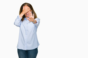 Beautiful middle age business adult woman over isolated background covering eyes with hands and doing stop gesture with sad and fear expression. Embarrassed and negative concept.