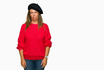 Middle age adult woman wearing fashion beret over isolated background skeptic and nervous, frowning upset because of problem. Negative person.