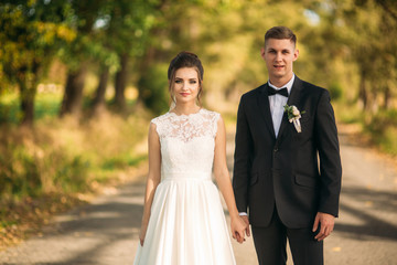 Romantic couple of newlyweds walking in the middle of alley