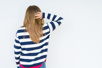 Beautiful middle age woman wearing navy sweater over isolated background Backwards thinking about doubt with hand on head