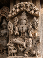 Fototapeta na wymiar Artistic stone sculptures and carvings of Hindu Gods and Goddesses at Somanathapura Temple in Karnataka, India. 