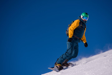 snowboarder running down the slope and ride free style