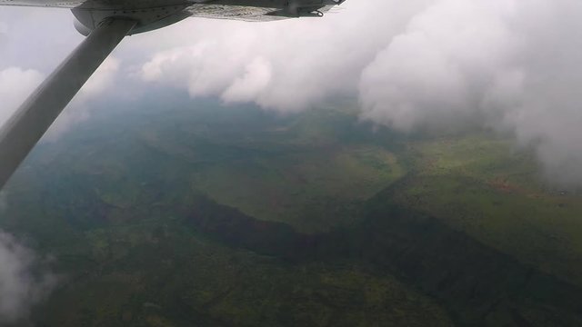 Aerial view flying over Kenyan mountains and through the clouds en route to Nairobi