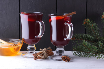 Mulled wine and Christmas tree branches on black and white background. Christmas mulled wine,...