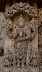 Fototapeta na wymiar Artistic stone sculptures and carvings of Hindu Gods & Goddesses at Somanathapura Temple in Karnataka, India. 