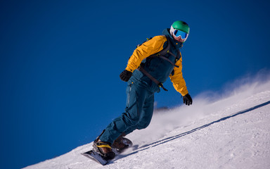snowboarder running down the slope and ride free style