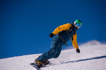 snowboarder running down the slope and ride free style