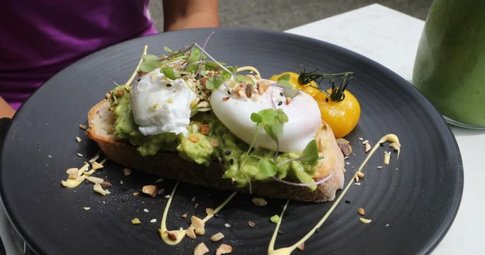 Avocado toast with poached egg - traditional hipster breakfast or brunch meal.