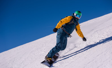 snowboarder running down the slope and ride free style