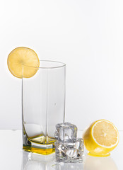 A glass of lemonade on a light background with splashing water