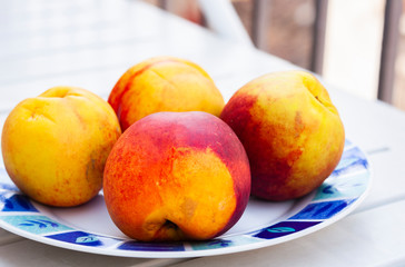 Fresh ripe peaches on the plate