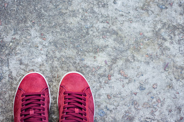Sneakers of pink suede on the sidewalk