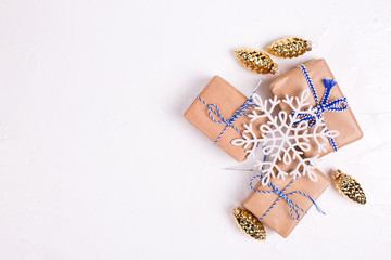 Wrapped boxes with presents, snowflake and golden decorative pine cones