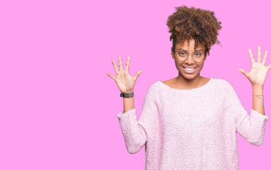 Beautiful young african american woman wearing glasses over isolated background showing and pointing up with fingers number ten while smiling confident and happy.