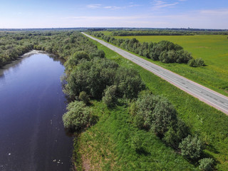 road in a field by the river