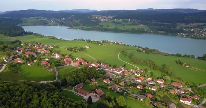 Aerial, pan, drone shot, of houses in les grangettes village, near Lac saint-point lake, in Franche comt&radic;&copy;, France