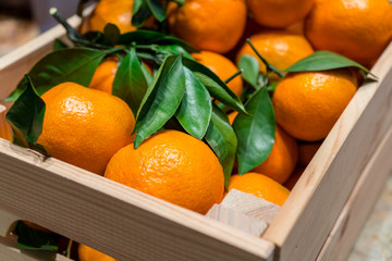 Fresh orange mandarins in the wooden box