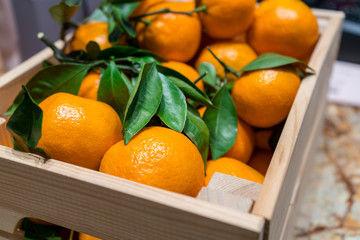 Fresh orange mandarins in the wooden box
