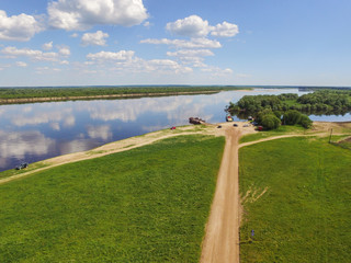 road in a field by the river