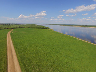 road in a field by the river