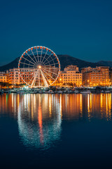 Fototapeta na wymiar Ferris wheel at the harbor at night, in Salerno, Italy.