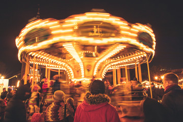 Christmas celebrations in Gdansk, Poland: bright carousel spinning at the city center