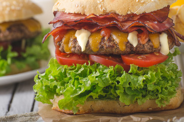 Homemade bacon burger with lettuce and cheddar