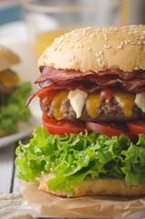 Homemade bacon burger with lettuce and cheddar