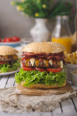 Homemade bacon burger with lettuce and cheddar