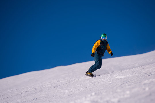 snowboarder running down the slope and ride free style