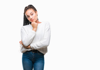 Young braided hair african american girl wearing winter sweater over isolated background looking confident at the camera with smile with crossed arms and hand raised on chin. Thinking positive.