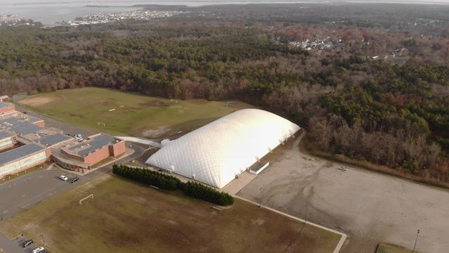 Aerial shot flying over a school's inflated stadium.