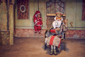 Handmade wooden puppet theater. King and Jester. Selective focus