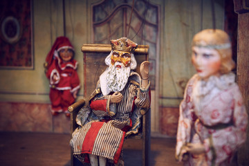 Handmade wooden puppet theater. King and princess. Selective focus