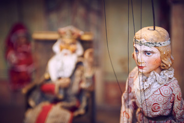 Handmade wooden puppet theater. King and princess. Selective focus